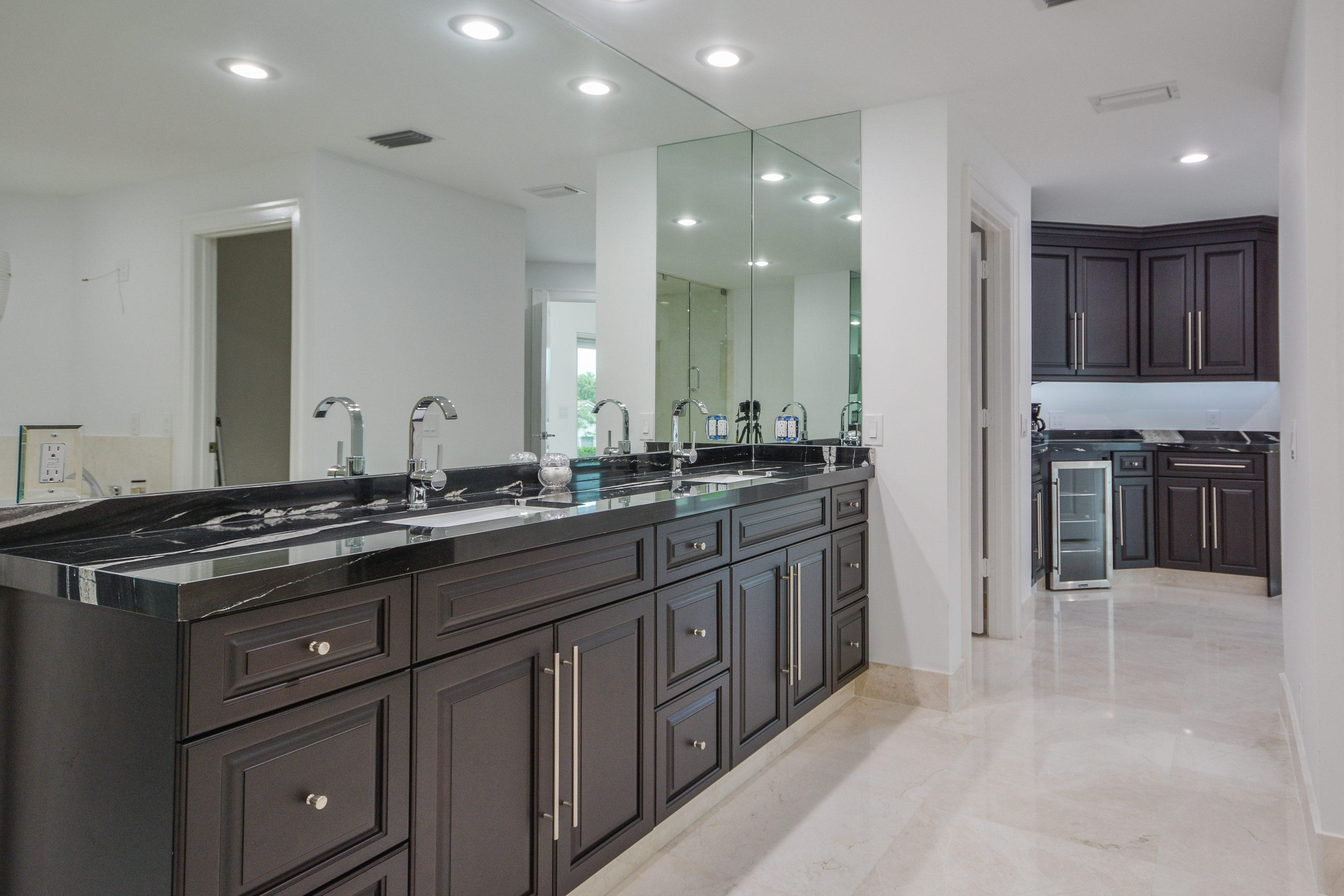 1041 Southwest 21st Avenue Boca Raton, FL 33486 - Photo 12 of 67 a large kitchen with stainless steel appliances granite countertop a sink and cabinets