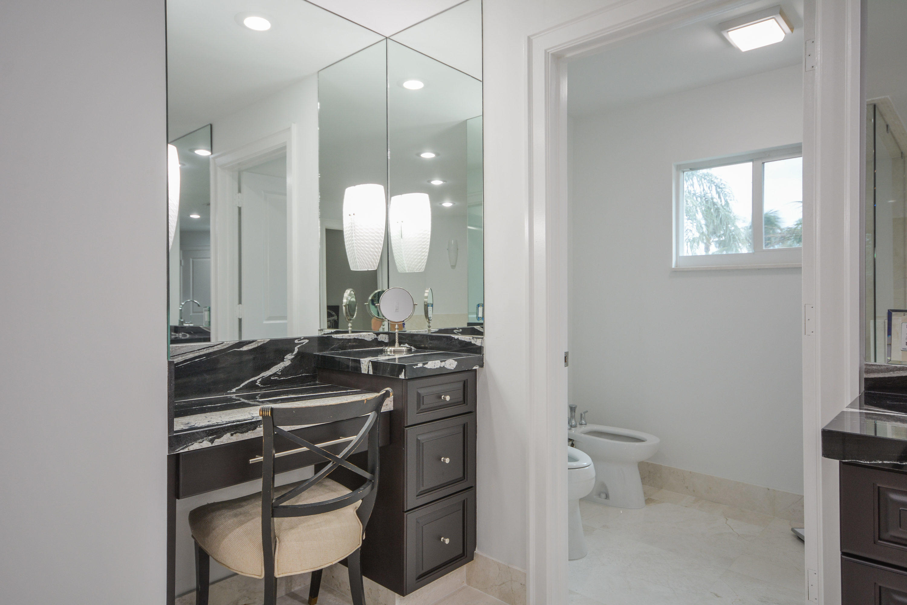 1041 Southwest 21st Avenue Boca Raton, FL 33486 - Photo 13 of 67 a bathroom with a sink a toilet a mirror and vanity