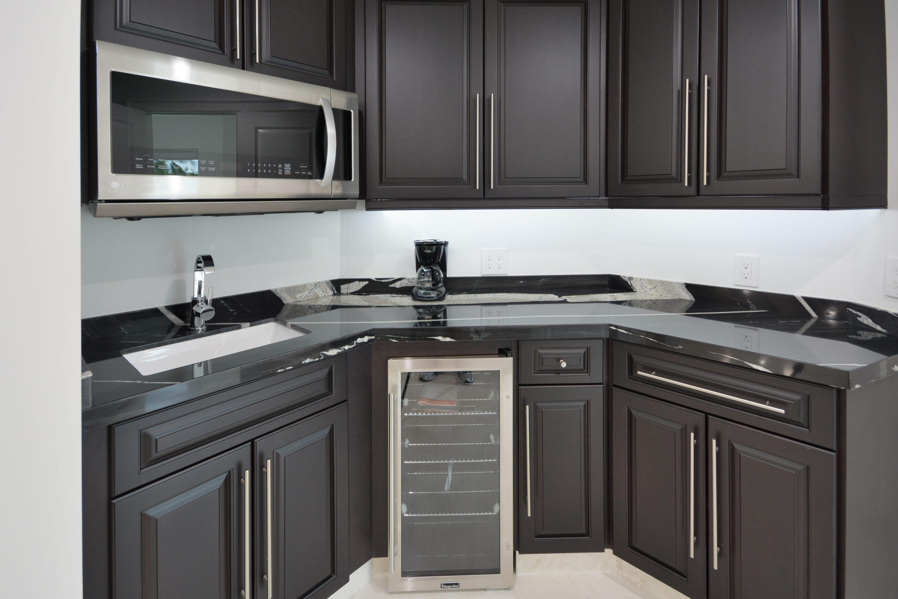1041 Southwest 21st Avenue Boca Raton, FL 33486 - Photo 14 of 67 a kitchen with stainless steel appliances granite countertop a stove and a microwave