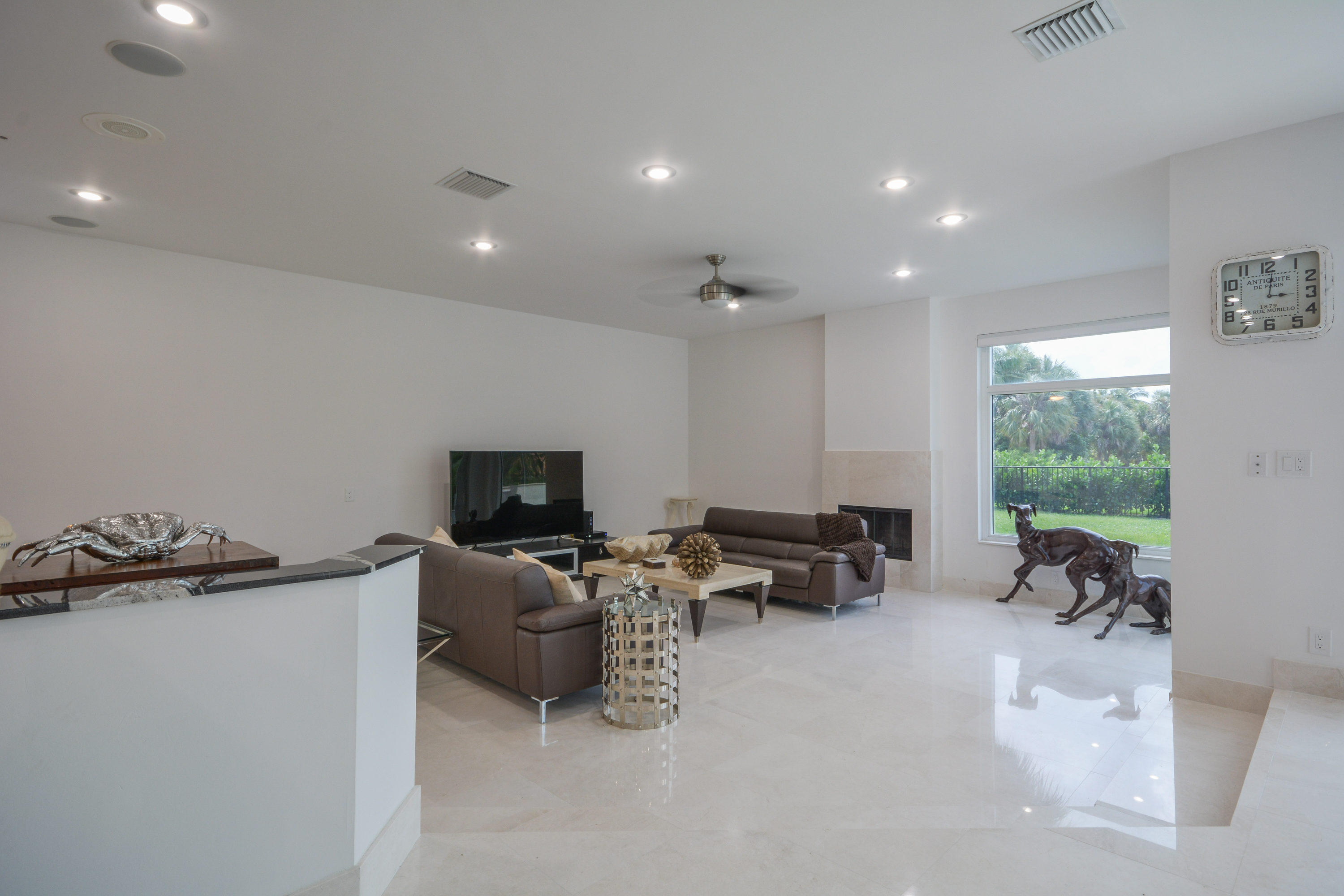 1041 Southwest 21st Avenue Boca Raton, FL 33486 - Photo 22 of 67 a living room with furniture a flat screen tv and a large window