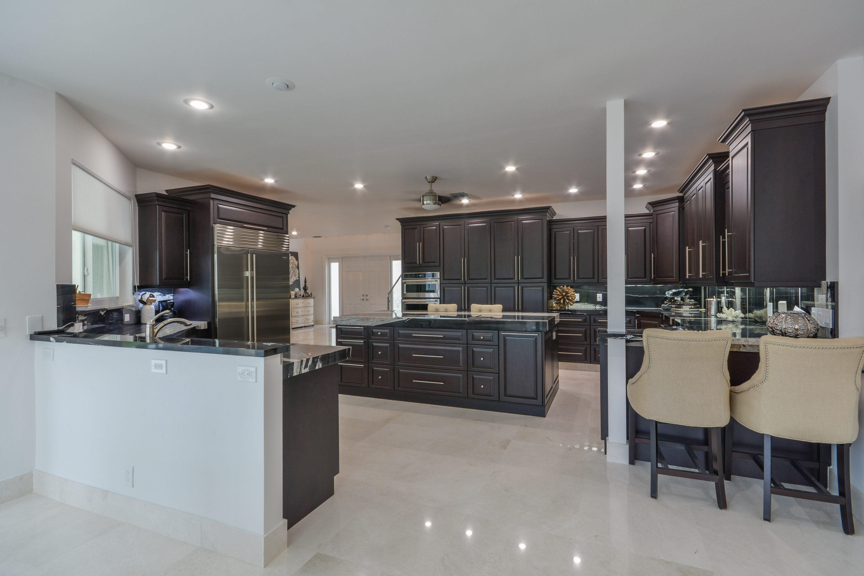1041 Southwest 21st Avenue Boca Raton, FL 33486 - Photo 24 of 67 a kitchen with a sink and a refrigerator