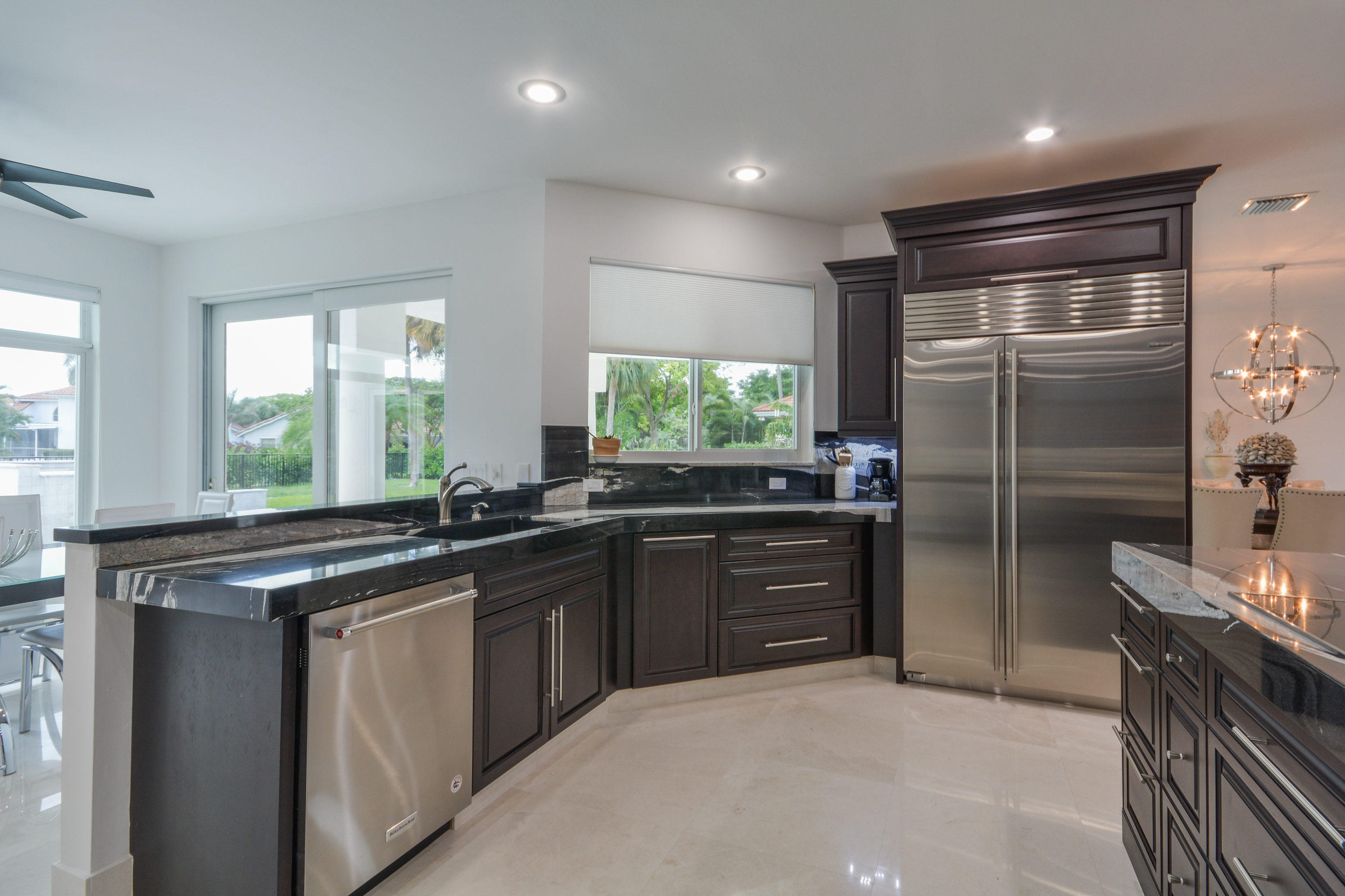 1041 Southwest 21st Avenue Boca Raton, FL 33486 - Photo 27 of 67 a kitchen with stainless steel appliances granite countertop a sink stove and refrigerator