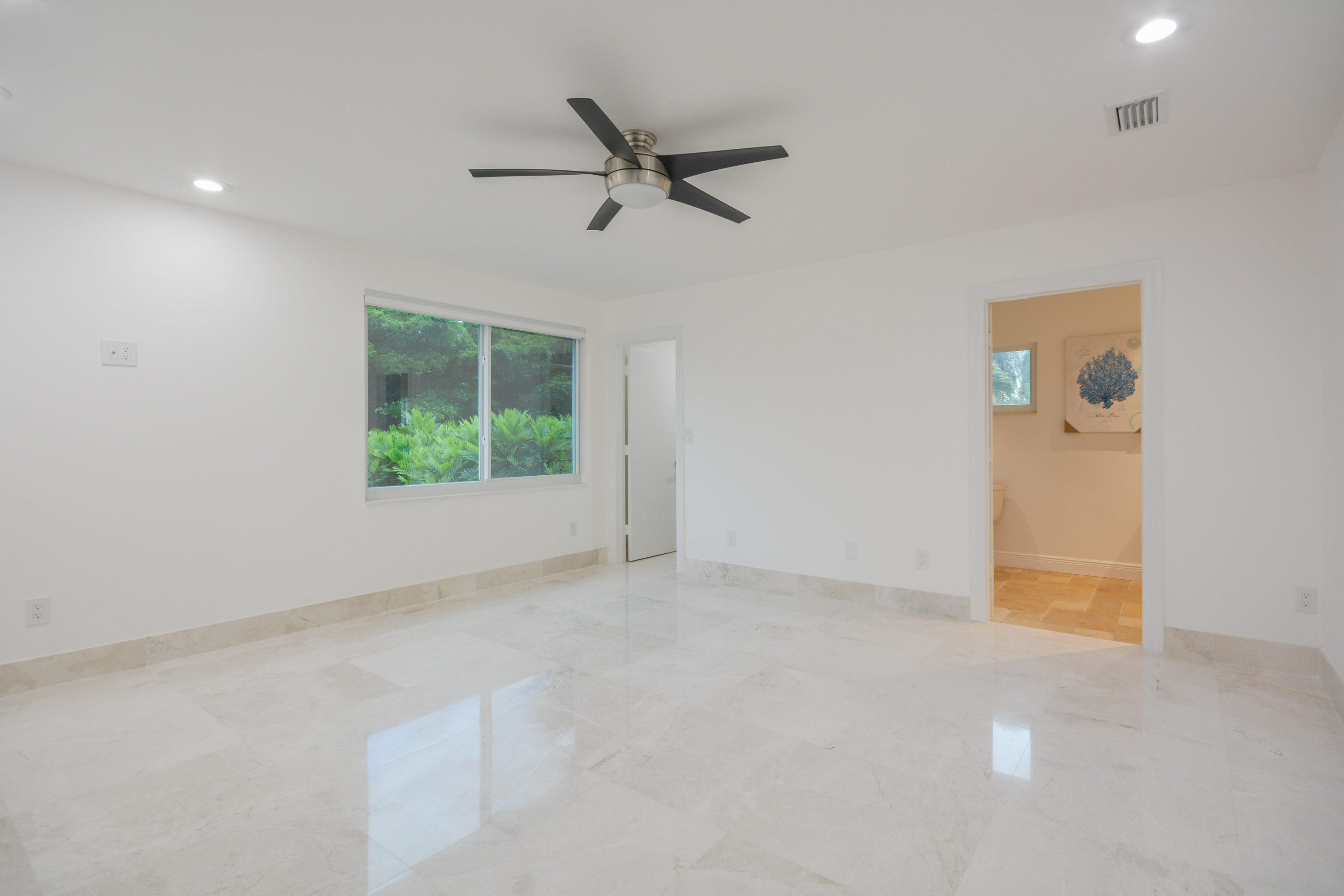 1041 Southwest 21st Avenue Boca Raton, FL 33486 - Photo 38 of 67 an empty room with a ceiling fan and windows