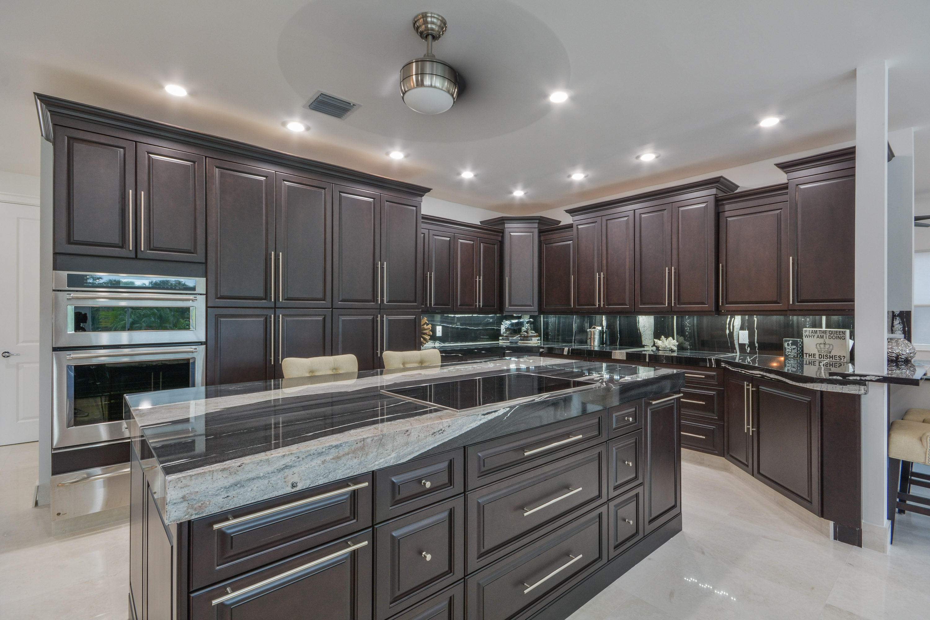 1041 Southwest 21st Avenue Boca Raton, FL 33486 - Photo 5 of 67 a kitchen with kitchen island granite countertop a sink stainless steel appliances and cabinets