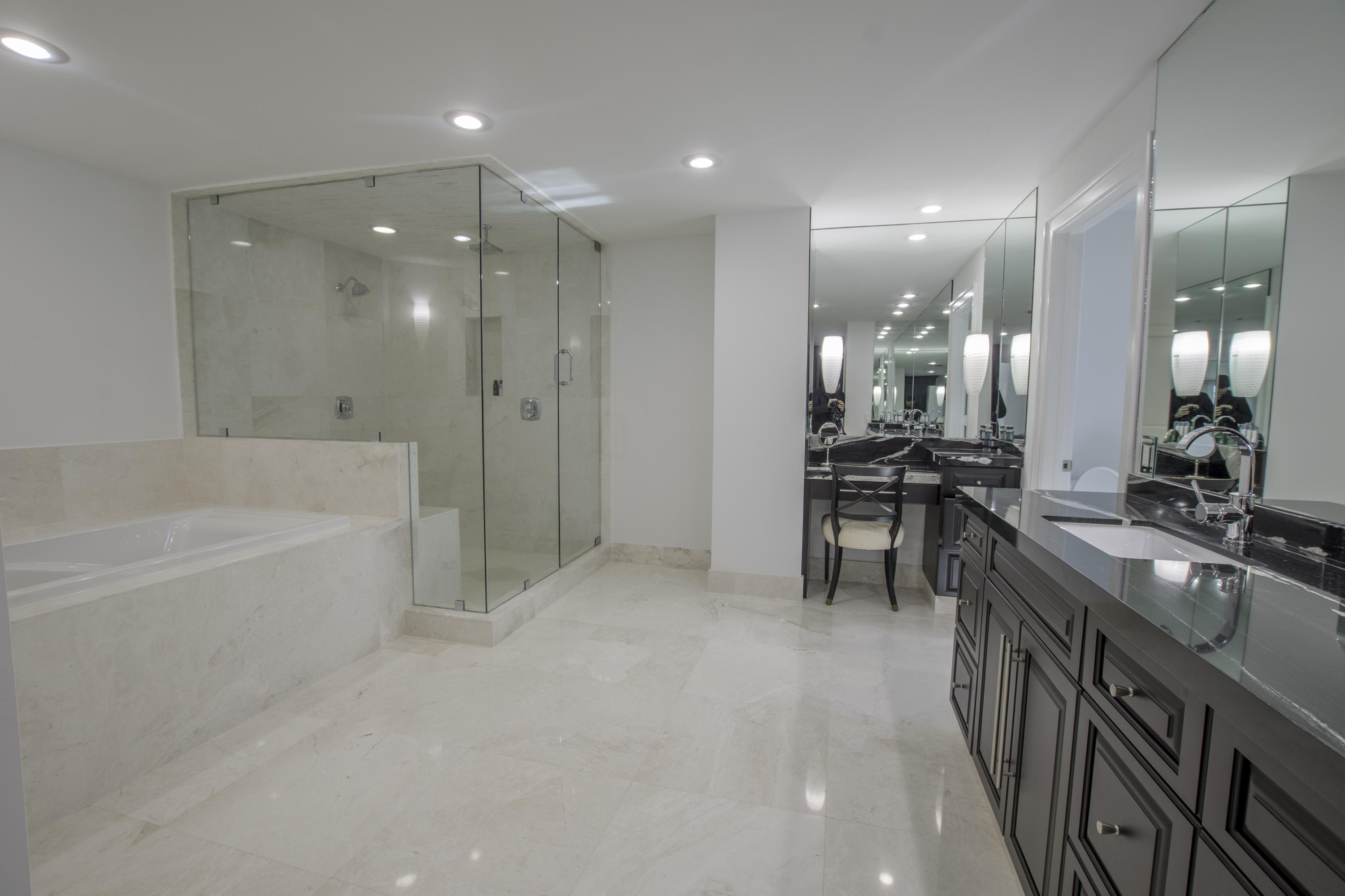 1041 Southwest 21st Avenue Boca Raton, FL 33486 - Photo 63 of 67 a bathroom with a tub a sink a mirror and a shower