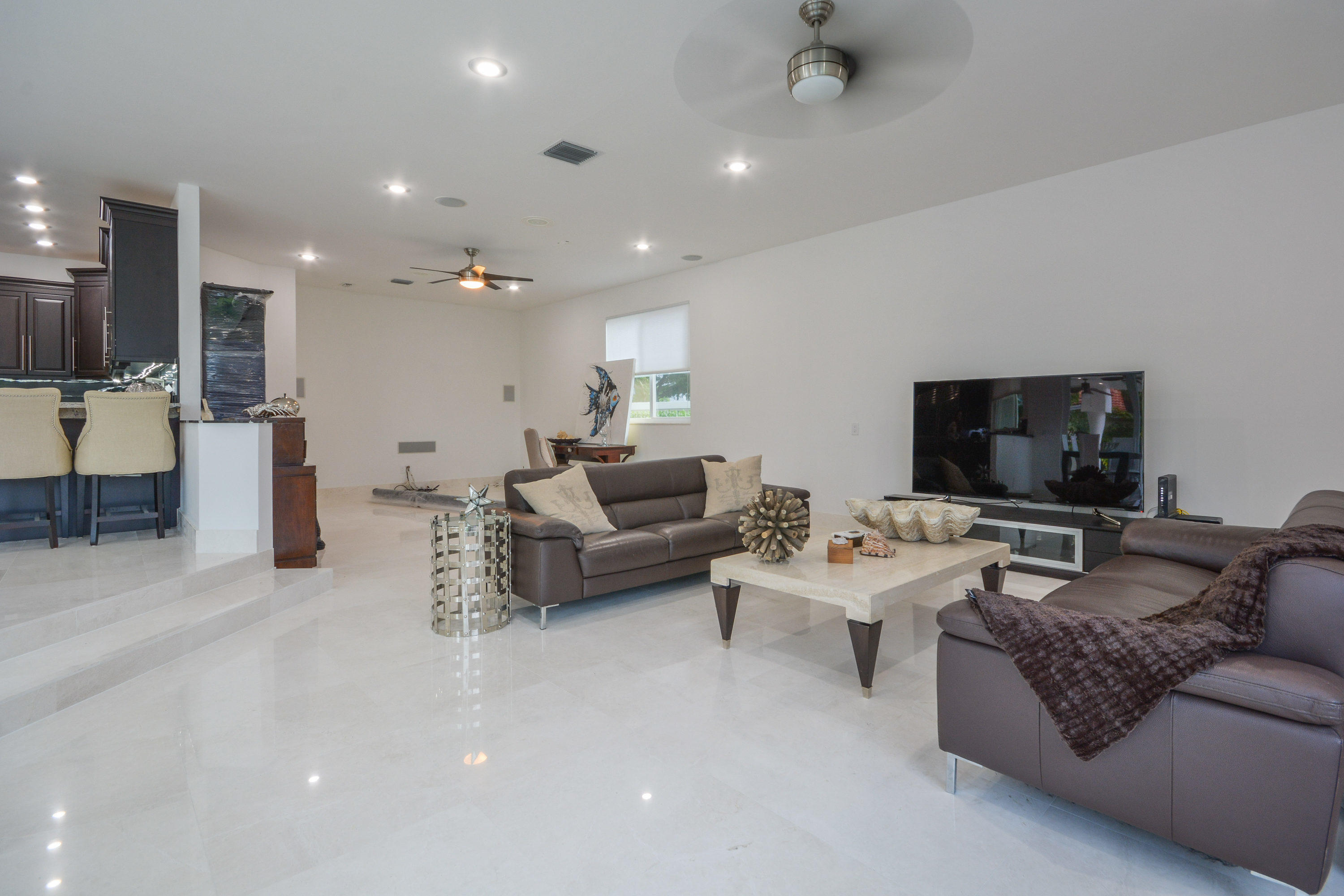 1041 Southwest 21st Avenue Boca Raton, FL 33486 - Photo 9 of 67 a living room with furniture and a flat screen tv