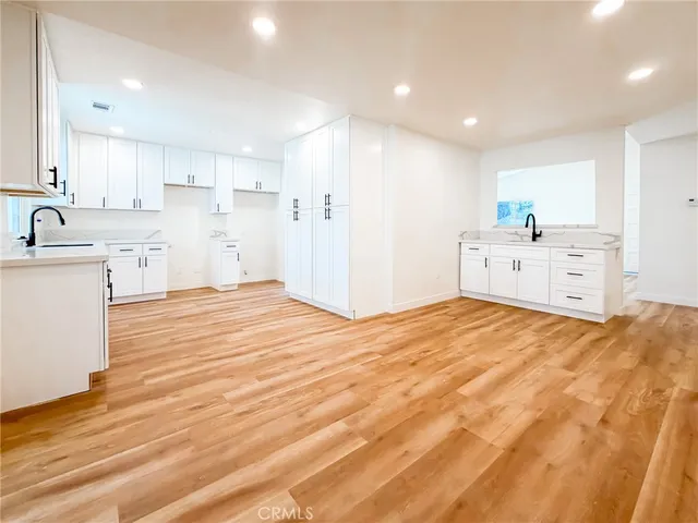 a large kitchen with a stove a sink dishwasher and a refrigerator