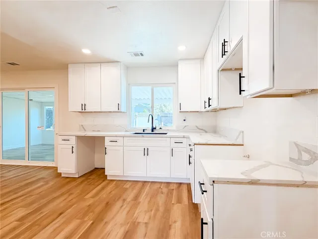 a kitchen with a sink a stove and cabinets