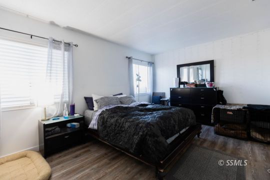 1221 Nocturne Street Ridgecrest, CA 93555 - Photo 17 of 32 a bedroom with a bed and a couch