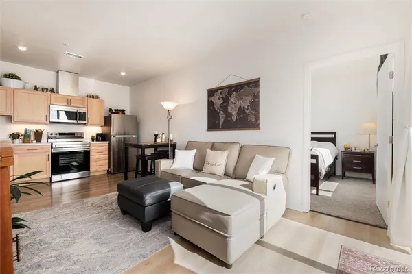 a living room with furniture and kitchen view