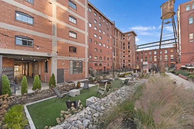 a view of a brick building next to a yard