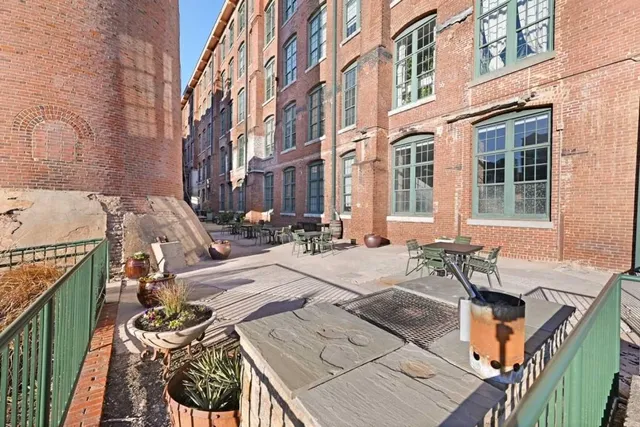 a view of a patio with couches chairs and a barbeque