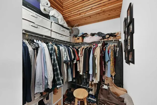 a view of walk in closet with clothes