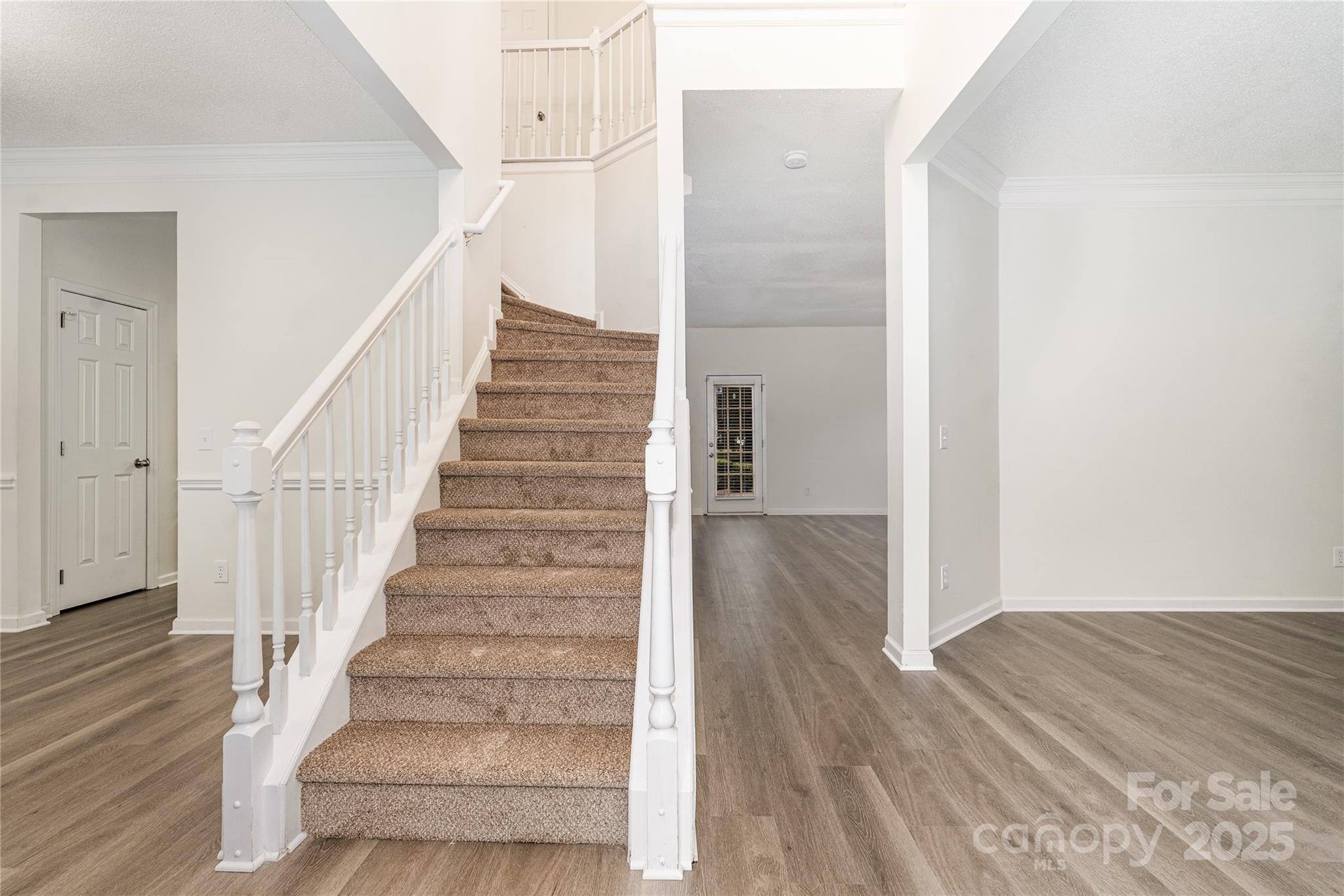 11422 Ridge Oak Drive Charlotte, NC 28273 - Photo 11 of 19 a view of staircase with wooden floor and white walls