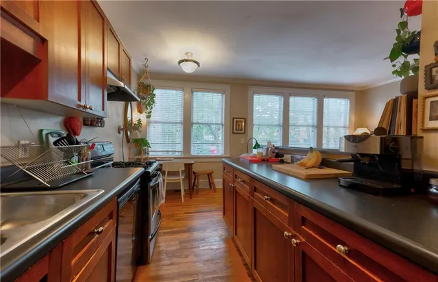 a kitchen with a sink stove and cabinets