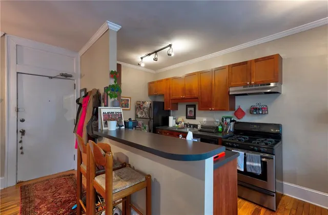 a kitchen with stainless steel appliances granite countertop a stove and a refrigerator