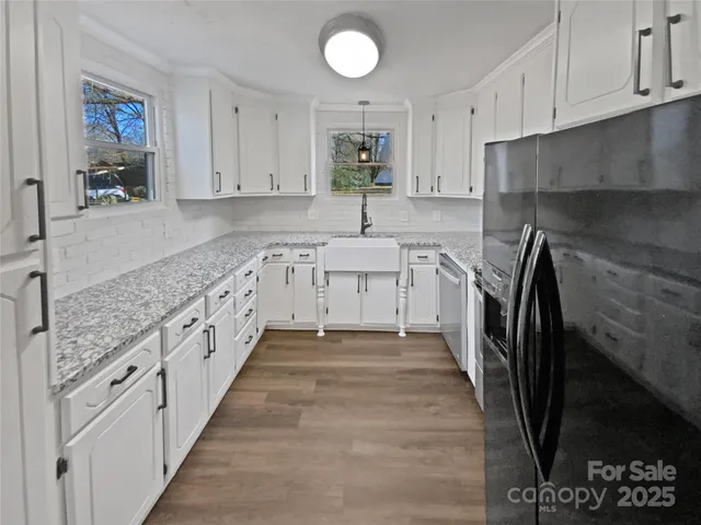 a large white kitchen with cabinets