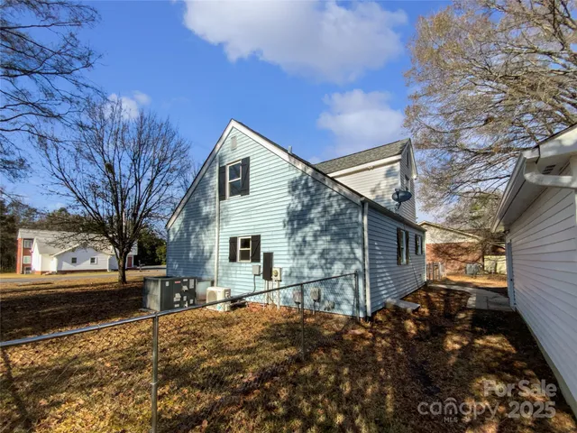 a backyard of a house with large trees