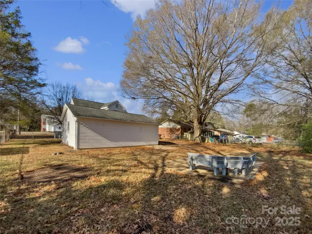 a view of a yard with a large tree