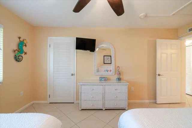 a bedroom with two beds and a chandelier