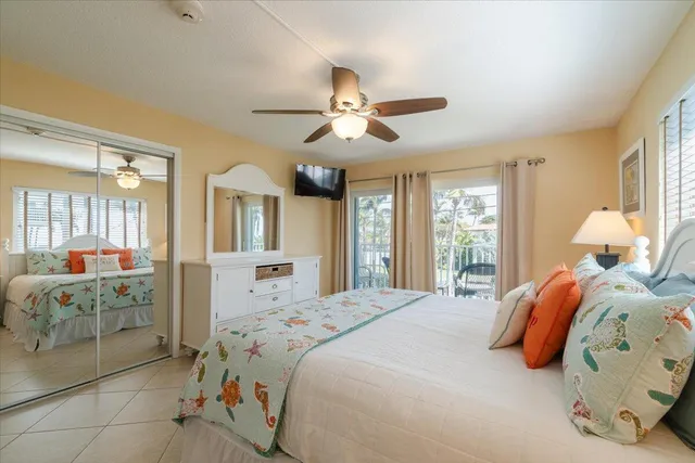 a bedroom with two beds and a chandelier