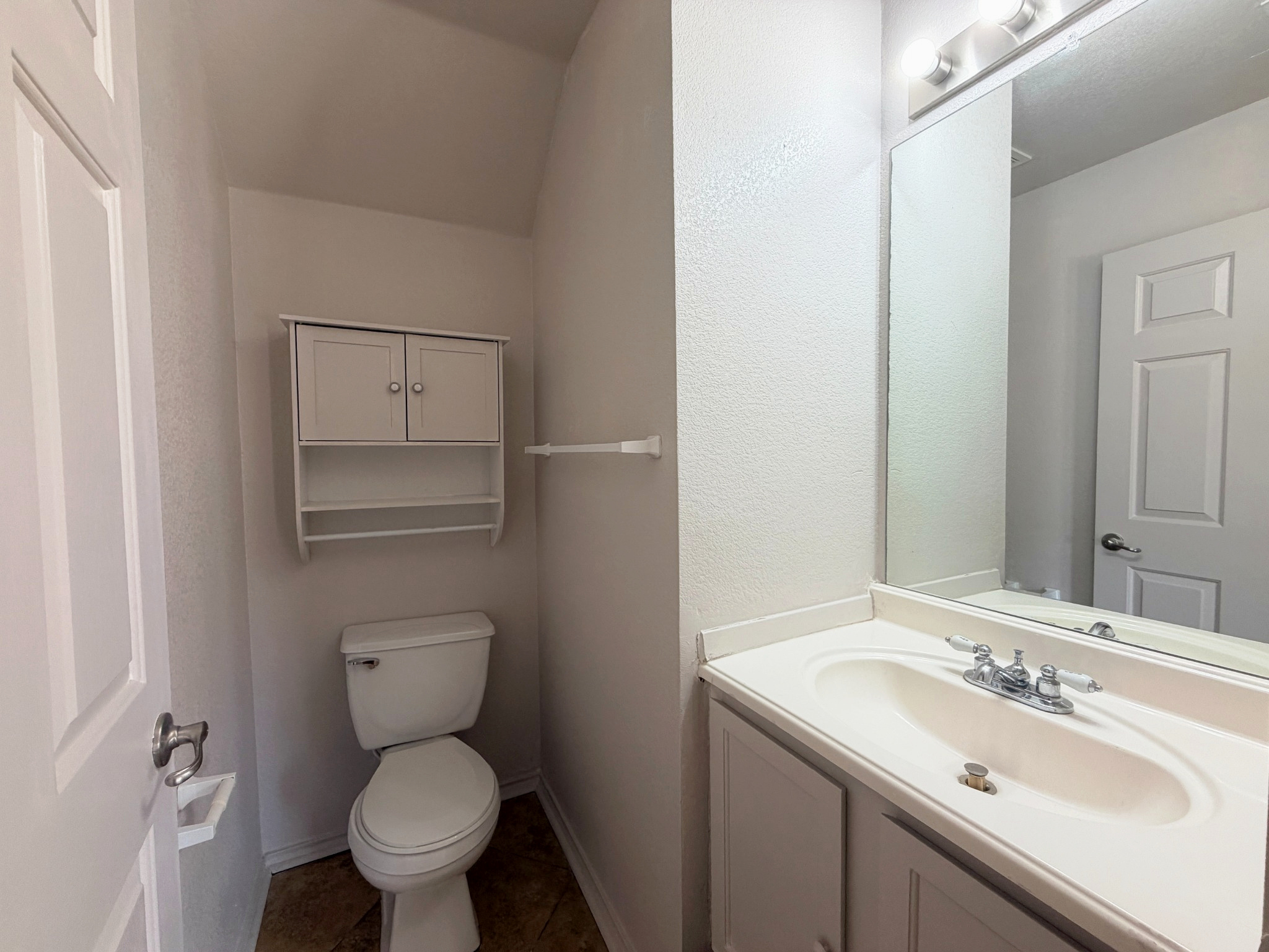 4601 Nuckols Crossing Road Austin, TX 78744 - Photo 6 of 18 Clean lines and classic fixtures define the powder room.