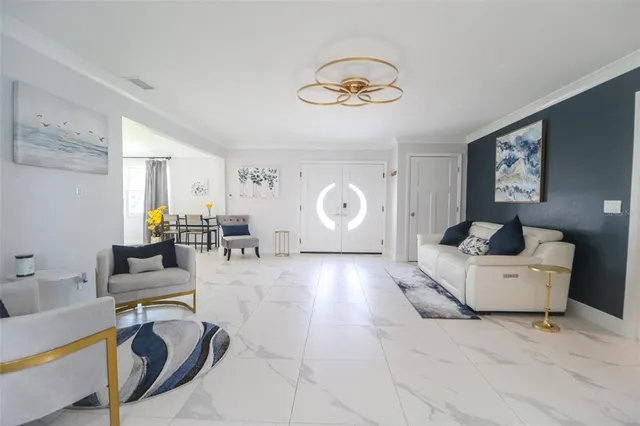 a living room with furniture and a potted plant