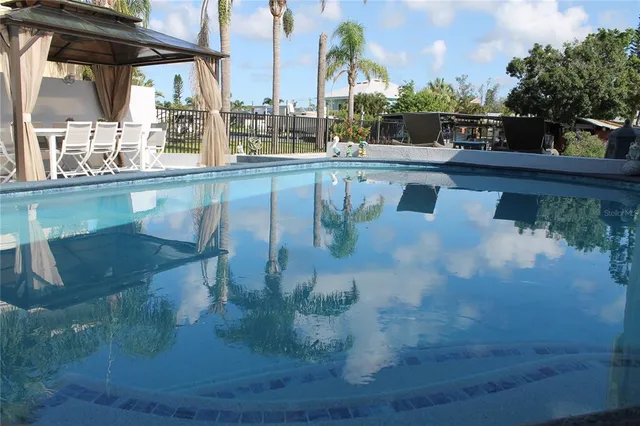 swimming pool view with a seating space