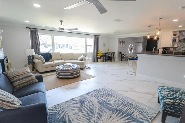 a view of kitchen with sink and refrigerator