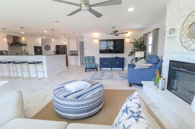 a living room with couch and a floor to ceiling window