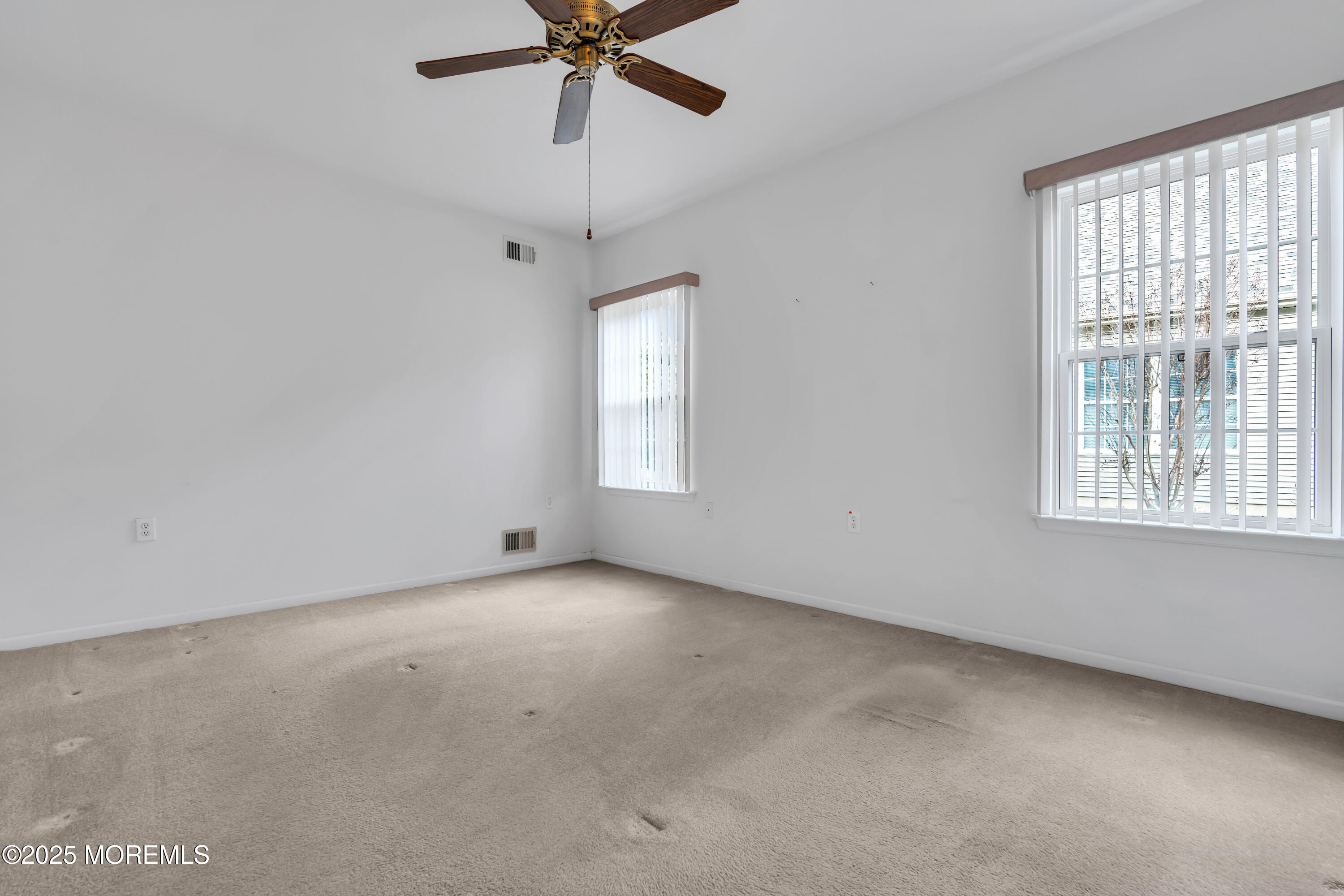 59 Drayton Road Manchester Township, NJ 08759 - Photo 17 of 38 an empty room with a window and a fan
