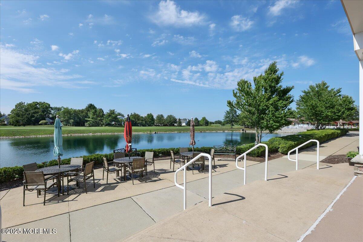 59 Drayton Road Manchester Township, NJ 08759 - Photo 28 of 38 a view of a patio with table and chairs with plants and lake view