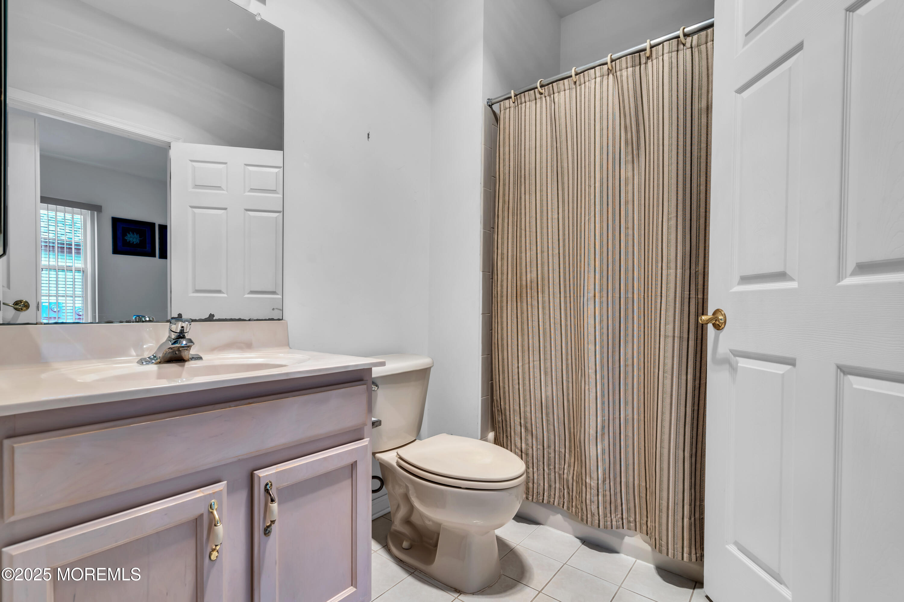 59 Drayton Road Manchester Township, NJ 08759 - Photo 10 of 38 a bathroom with a toilet a sink and a mirror