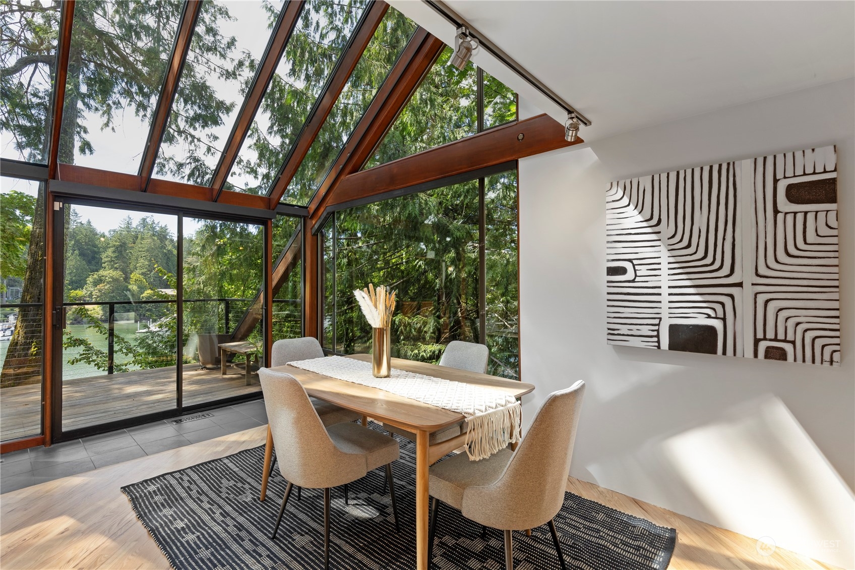 8100 Northeast Hidden Cove Road Bainbridge Island, WA 98110 - Photo 12 of 37 a dining room with furniture wooden floor and a potted plant