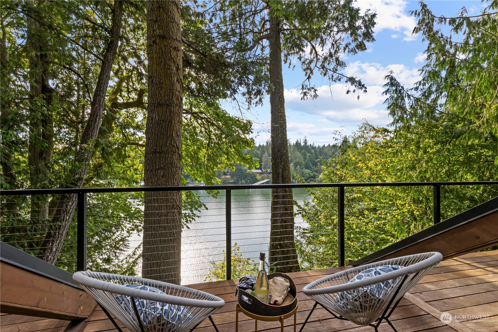 8100 Northeast Hidden Cove Road Bainbridge Island, WA 98110 - Photo 15 of 37 a view of a balcony with wooden floor and fence