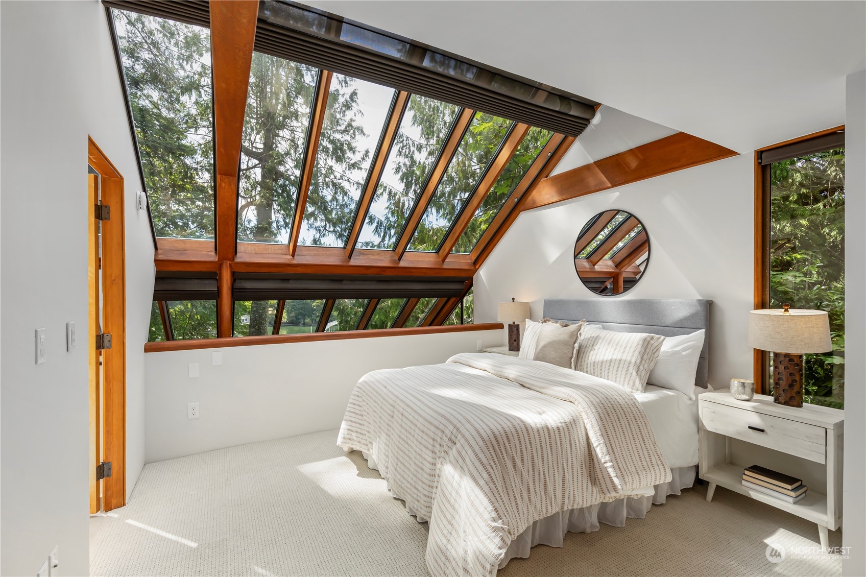 8100 Northeast Hidden Cove Road Bainbridge Island, WA 98110 - Photo 16 of 37 a bedroom with a bed and a large window