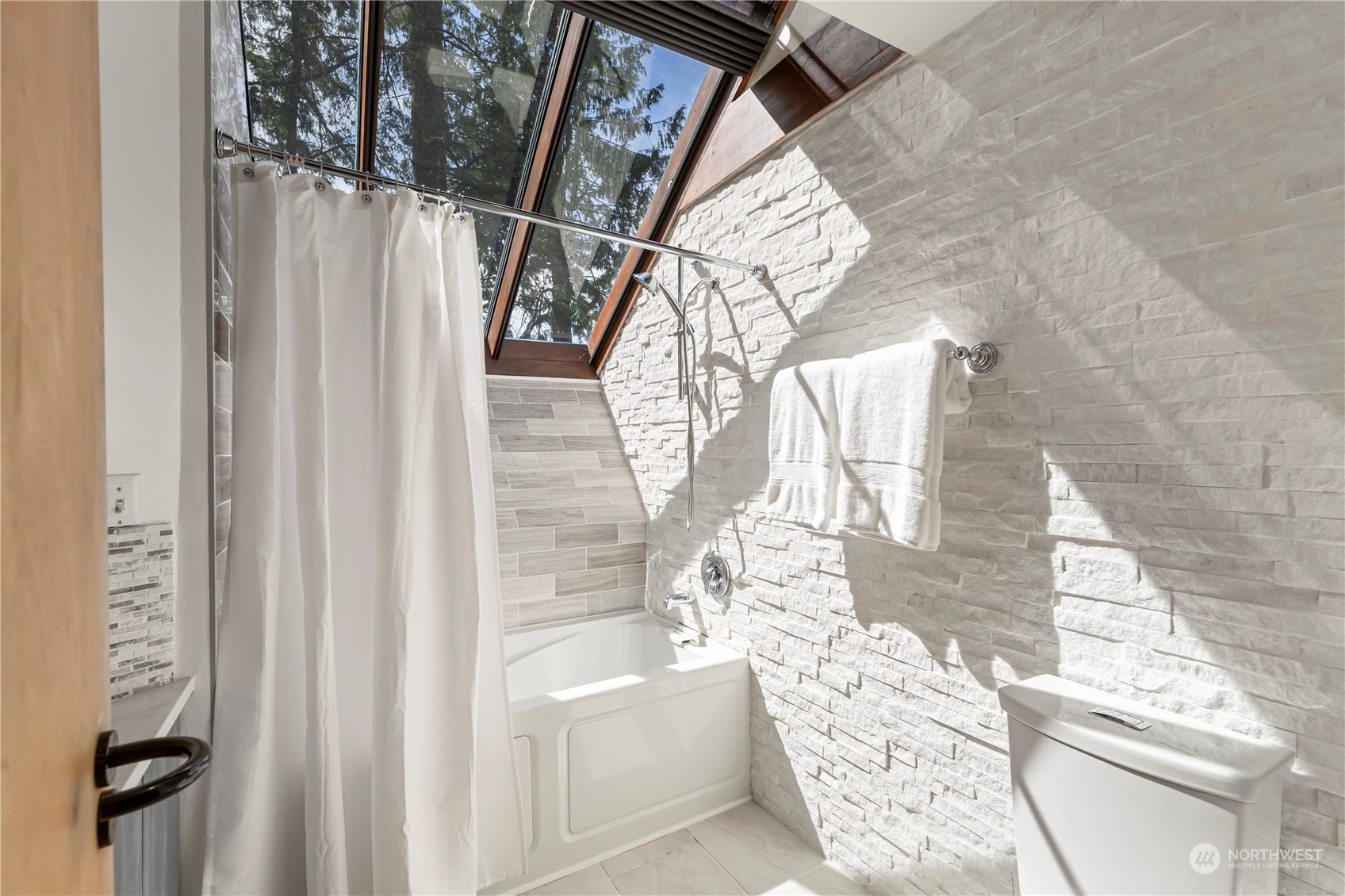 8100 Northeast Hidden Cove Road Bainbridge Island, WA 98110 - Photo 20 of 37 a bathroom with a bathtub and shower