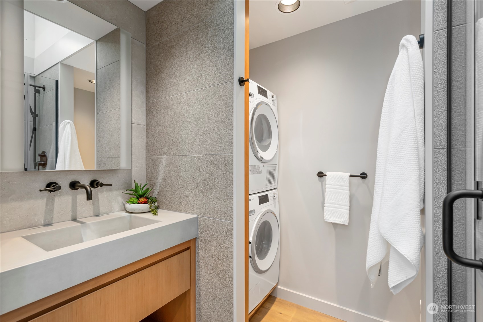 8100 Northeast Hidden Cove Road Bainbridge Island, WA 98110 - Photo 27 of 37 a bathroom with a sink a washer and dryer