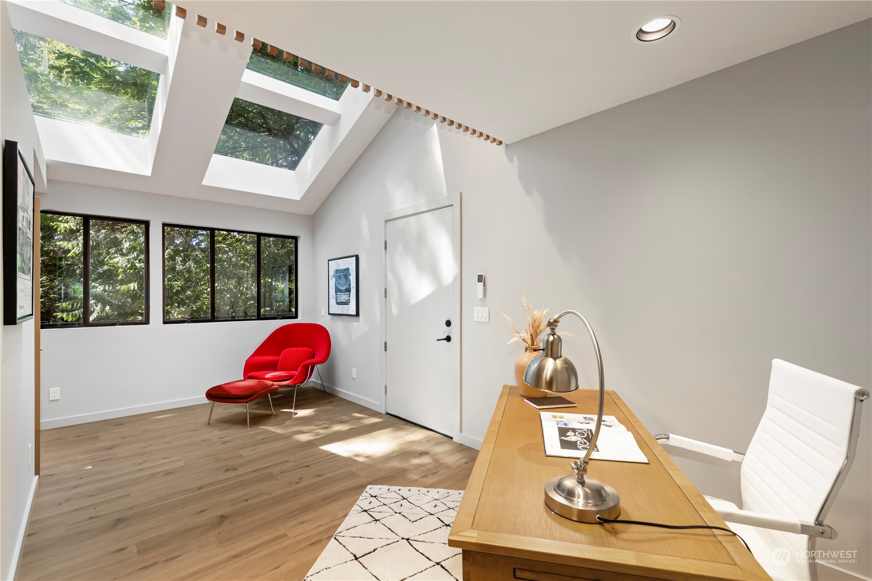 8100 Northeast Hidden Cove Road Bainbridge Island, WA 98110 - Photo 29 of 37 a view of a room with wooden floor and windows