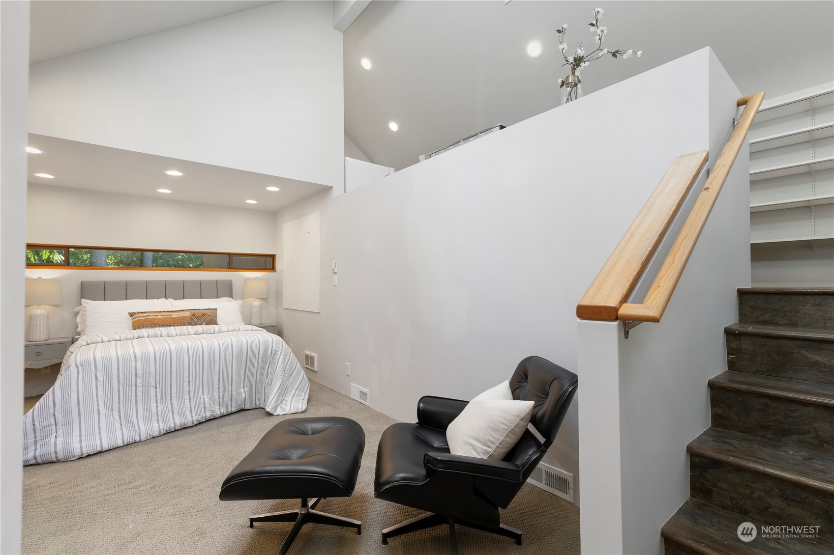 8100 Northeast Hidden Cove Road Bainbridge Island, WA 98110 - Photo 30 of 37 a bedroom with furniture and wooden floor
