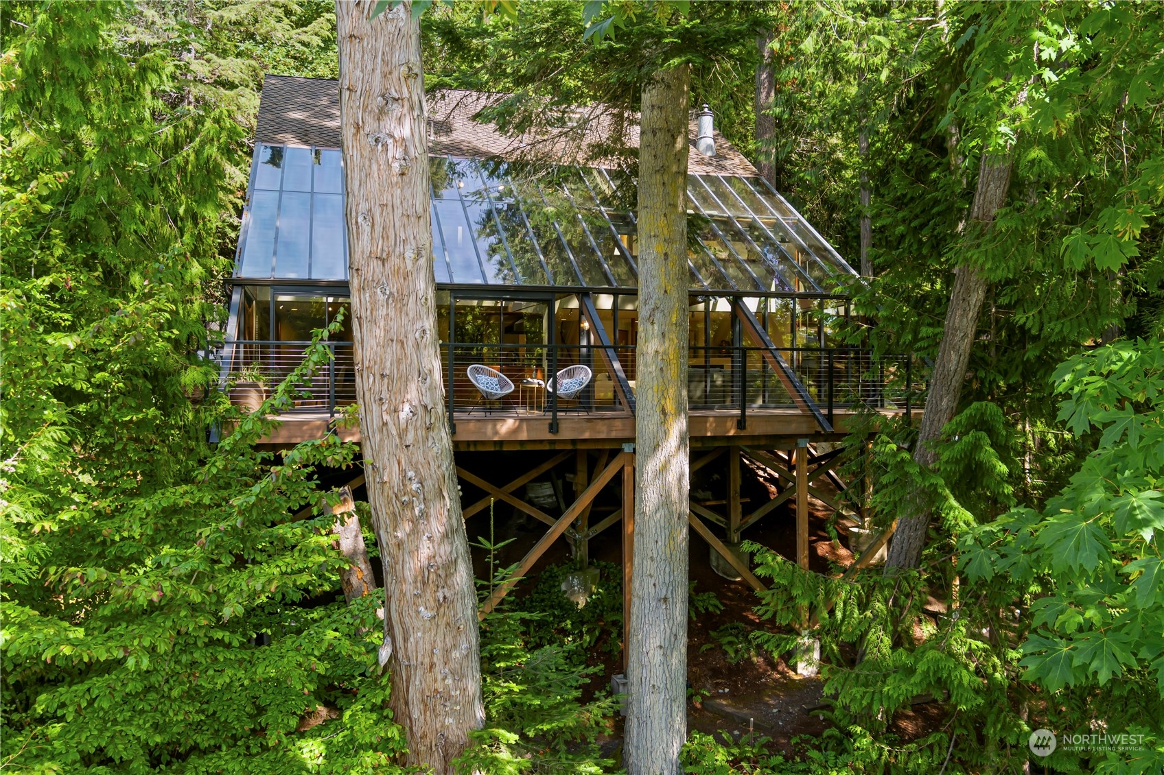 8100 Northeast Hidden Cove Road Bainbridge Island, WA 98110 - Photo 3 of 37 front view of a house with a tree