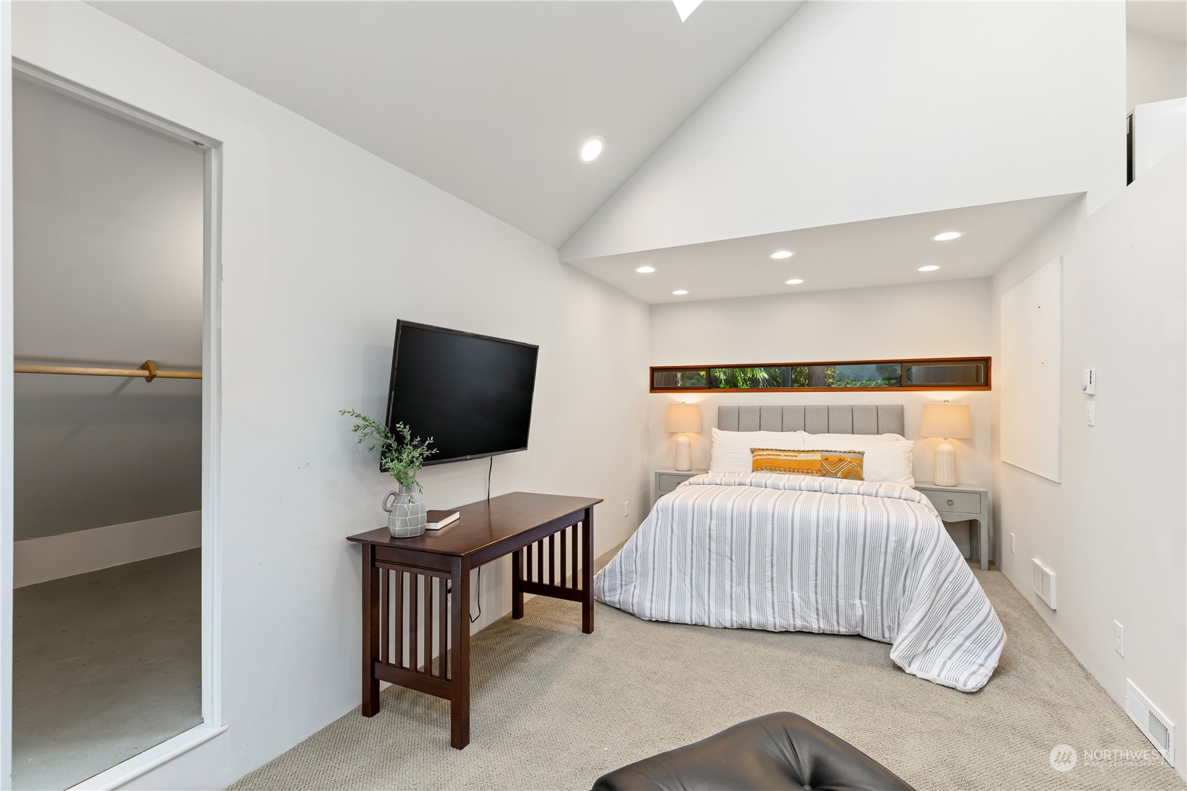 8100 Northeast Hidden Cove Road Bainbridge Island, WA 98110 - Photo 31 of 37 a bedroom with furniture and a flat screen tv