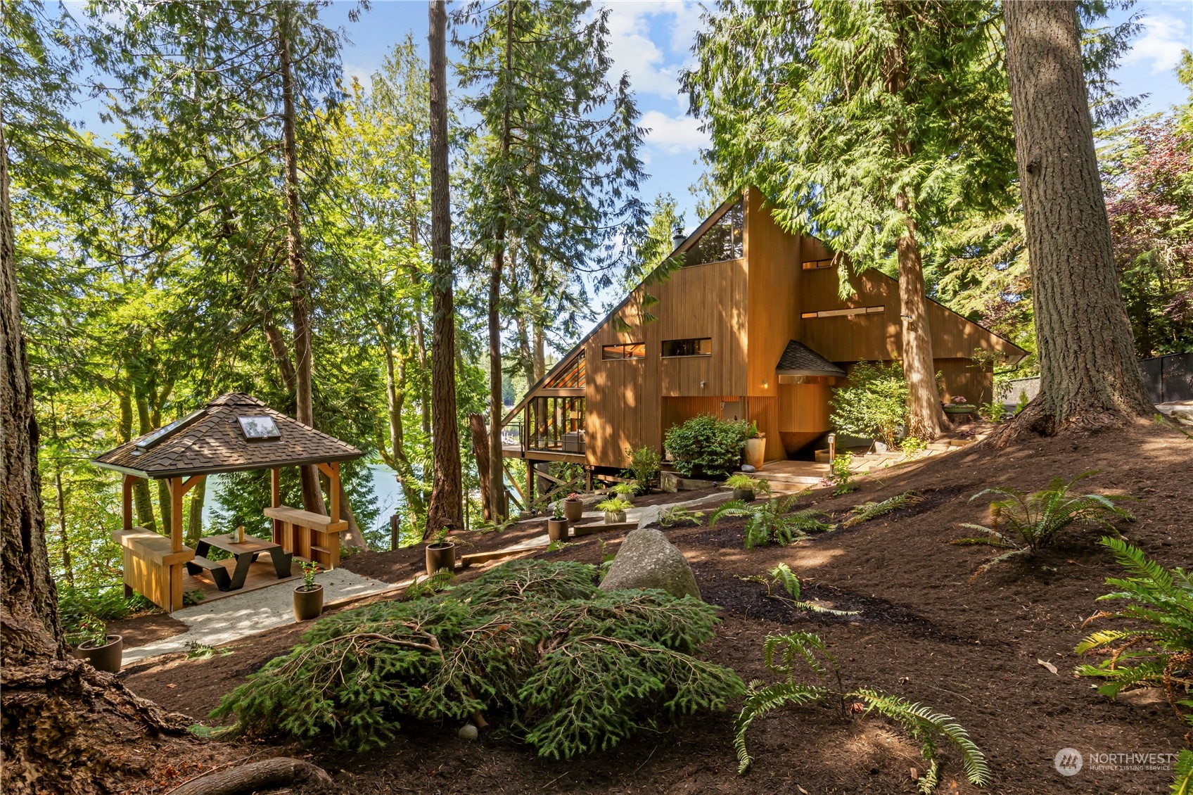 8100 Northeast Hidden Cove Road Bainbridge Island, WA 98110 - Photo 6 of 37 an outdoor space with patio and umbrella