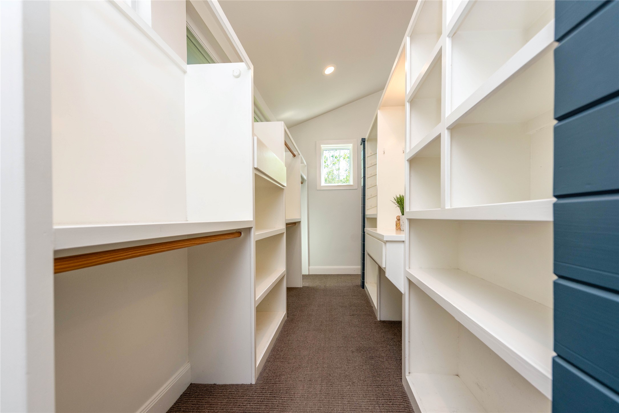 503 East 46th Street Austin, TX 78751 - Photo 15 of 25 Custom built-in shelving and cabinetry with hanging rods, recessed lighting, and a small window