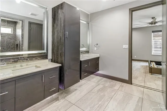 a spacious bathroom with a shower sink and mirror
