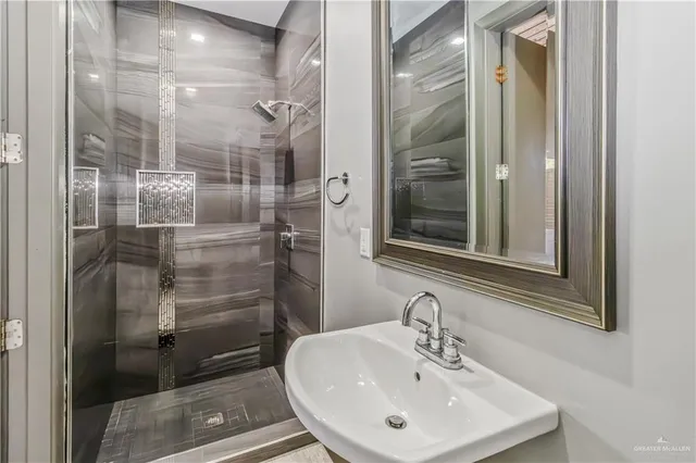 a bathroom with a shower and a sink