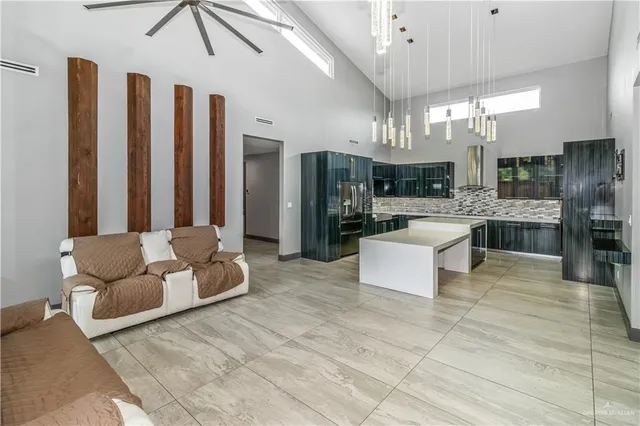 a living room with furniture and a chandelier