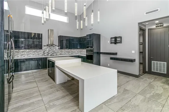 a kitchen with stainless steel appliances a stove a sink dishwasher and a refrigerator