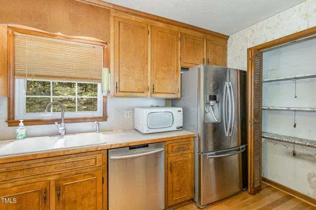 a kitchen with wooden cabinets and a stove top oven