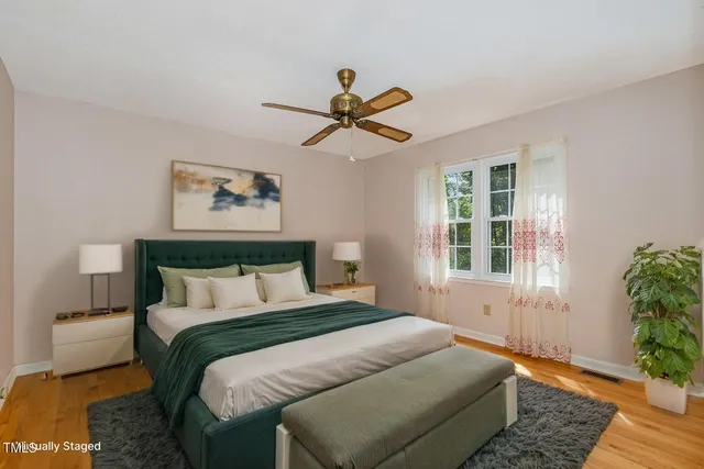 an empty room with a window and a ceiling fan